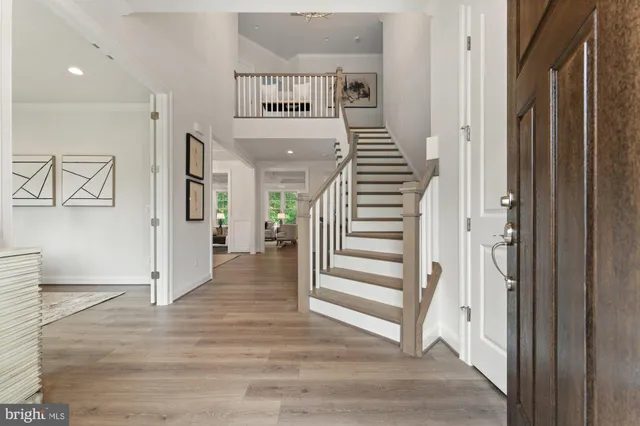 a view of entryway and hall with wooden floor