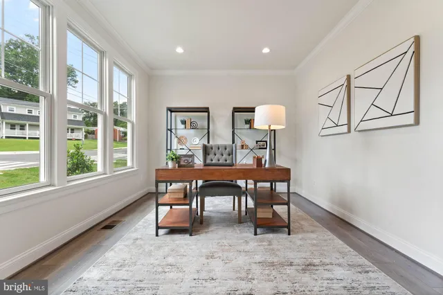 a view of a workspace with furniture and a window