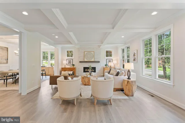 a living room with fireplace furniture and a large window