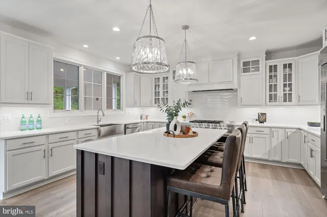 a kitchen with sink cabinets and dining table chairs