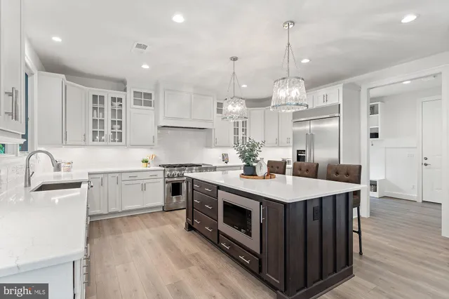 a open kitchen with stainless steel appliances granite countertop a sink stove and refrigerator