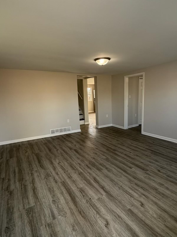 621 Mohawk Street Joliet, IL 60432 - Photo 11 of 15 an empty room with wooden floor and windows