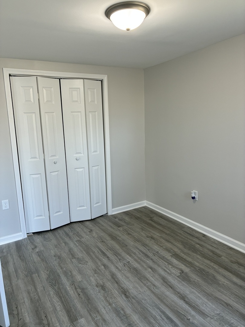 621 Mohawk Street Joliet, IL 60432 - Photo 14 of 15 a view of an empty room with wooden floor