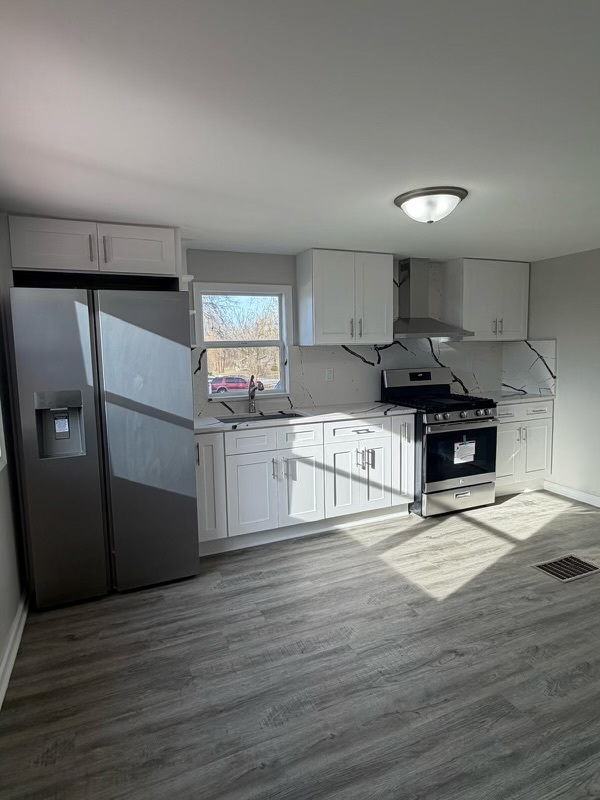 621 Mohawk Street Joliet, IL 60432 - Photo 6 of 15 a kitchen with stainless steel appliances granite countertop a refrigerator sink and cabinets