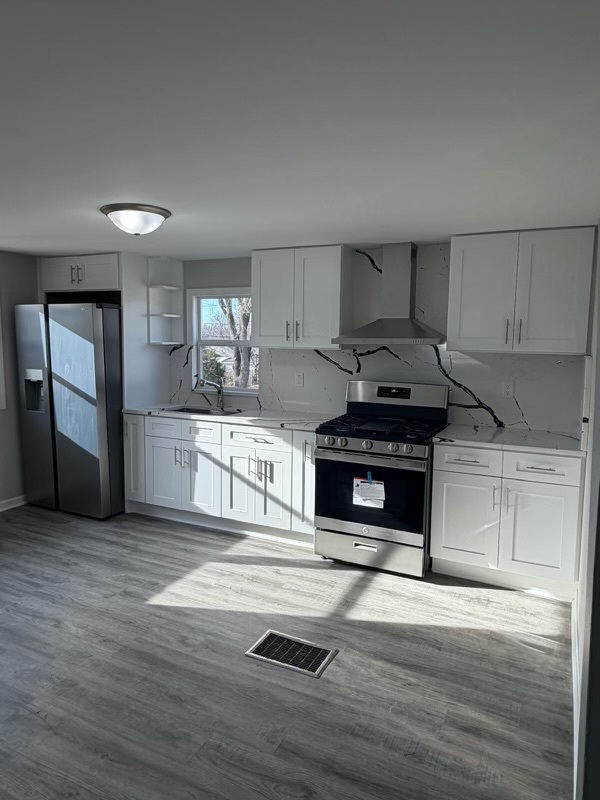 621 Mohawk Street Joliet, IL 60432 - Photo 7 of 15 a kitchen with granite countertop a stove and a sink