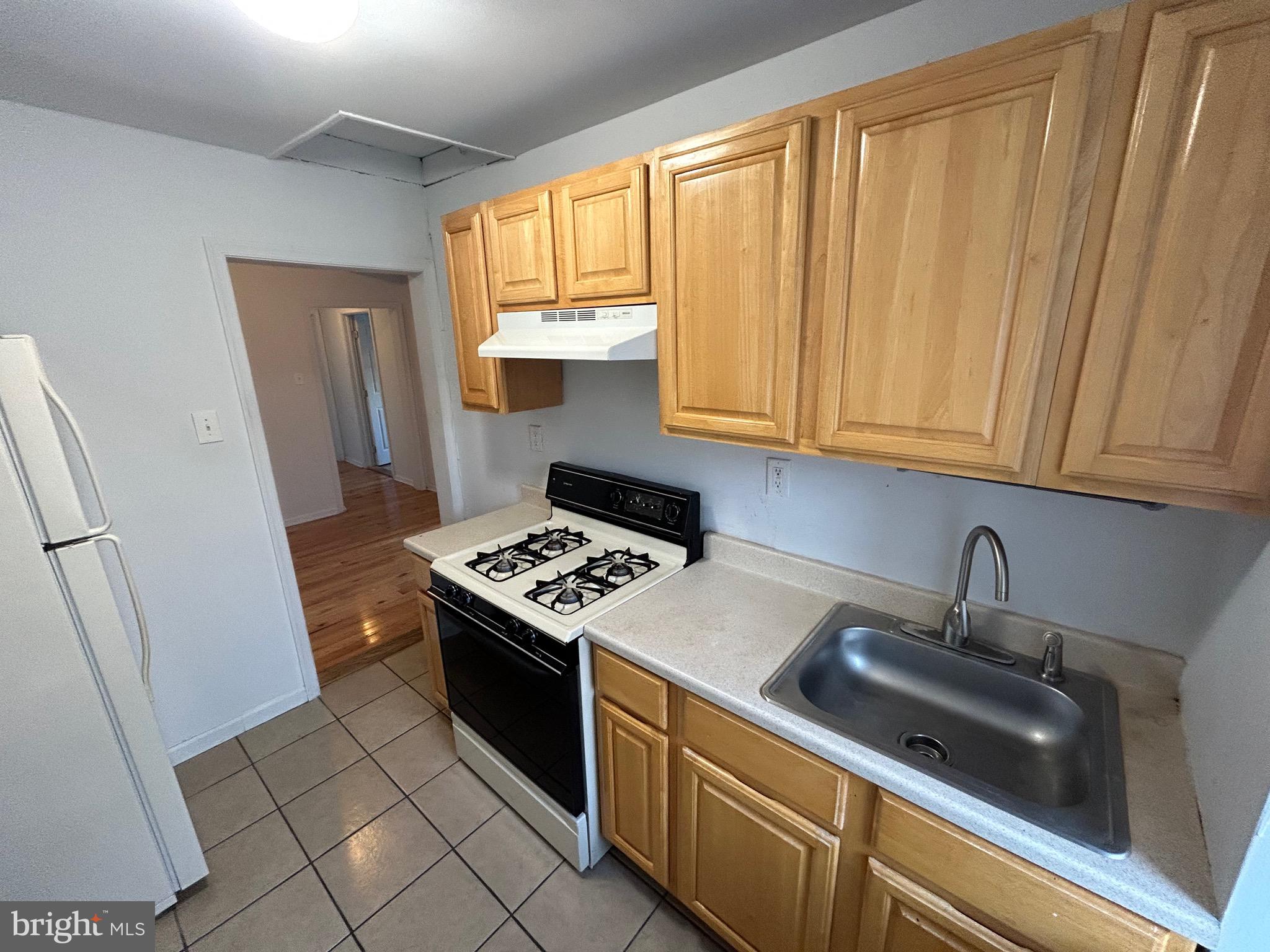 3800 Spring Garden Street Philadelphia, PA 19104 - Photo 34 of 35 a kitchen with stainless steel appliances a stove a sink and a refrigerator