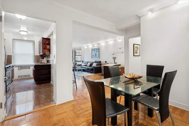 a dining room with furniture and wooden floor