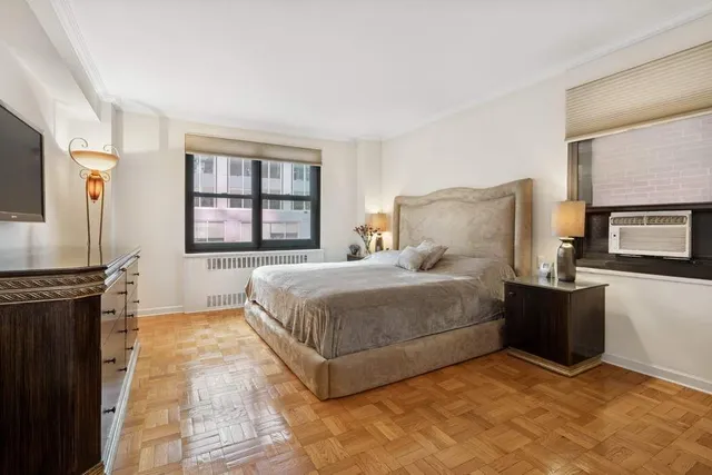 a bed room with a bed and a television