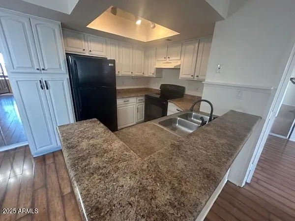 a kitchen with stainless steel appliances granite countertop a refrigerator and a sink