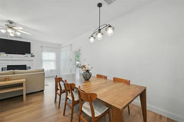 a view of a dining room with furniture wooden floor and a chandelier