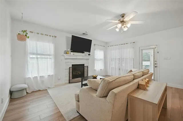 a living room with furniture a fireplace and a flat screen tv