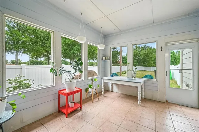 a room with furniture and large windows