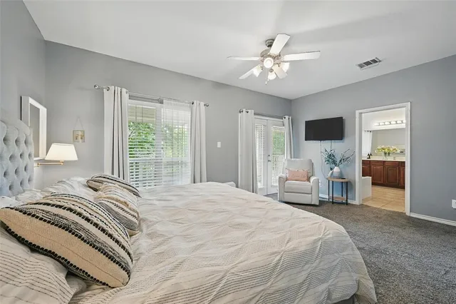a bedroom with a large bed and a chandelier