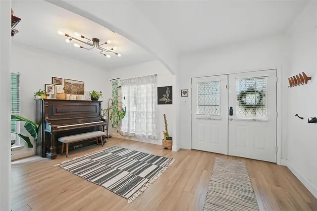 a view of a bedroom with furniture and wooden floor
