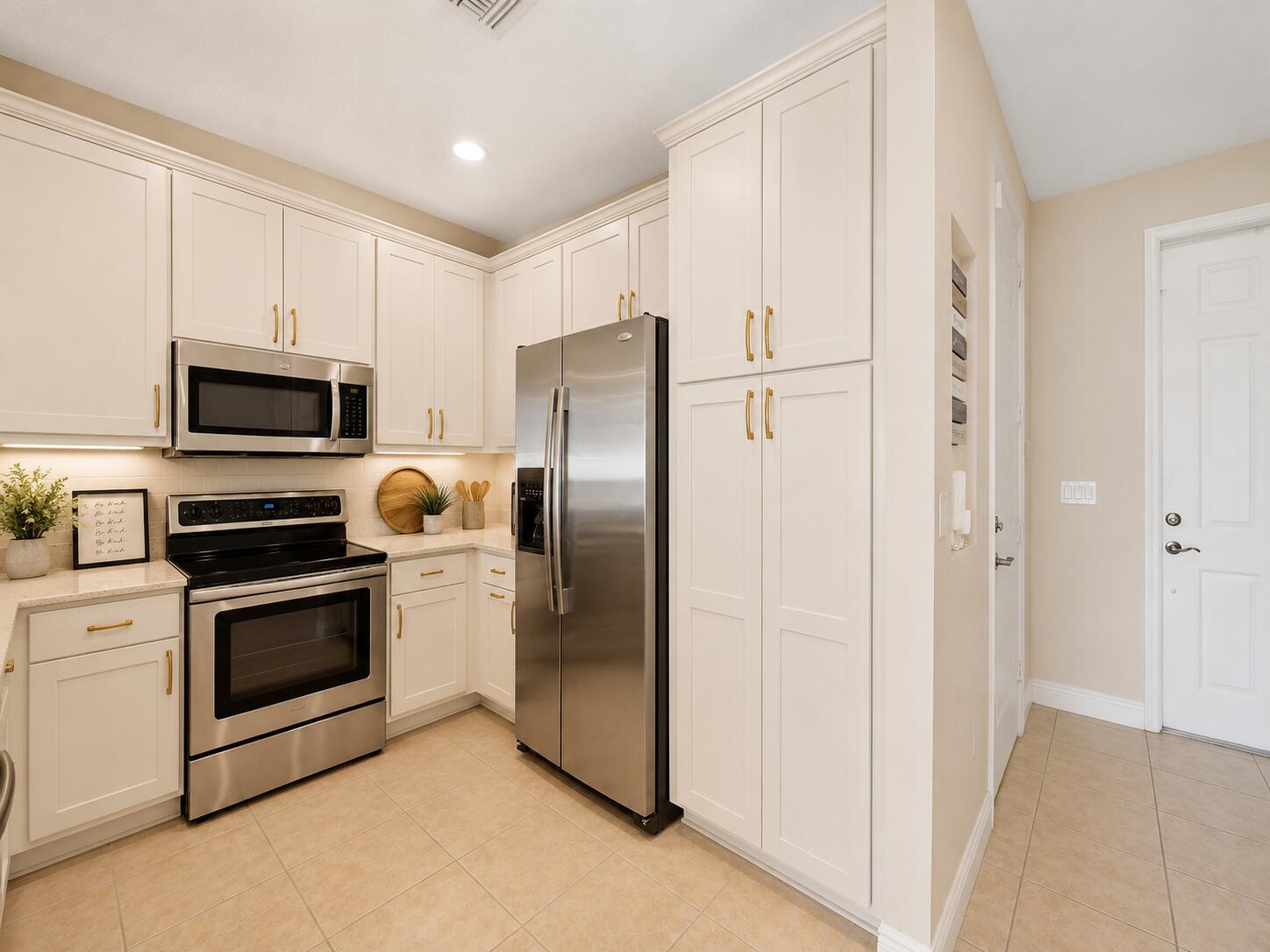 4792 Sundance Way, Unit 4792 Davie, FL 33328 - Photo 6 of 25 a kitchen with stainless steel appliances granite countertop a refrigerator a stove top oven a sink and dishwasher