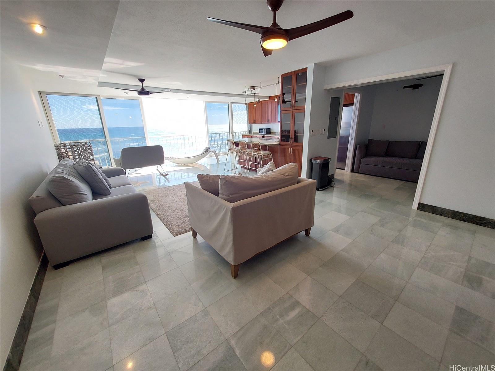 2801 Coconut Avenue, Unit 6B Honolulu, HI 96815 - Photo 2 of 12 a living room with furniture and a flat screen tv