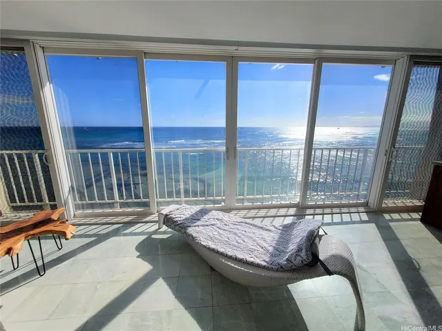 a living room with furniture and a floor to ceiling window
