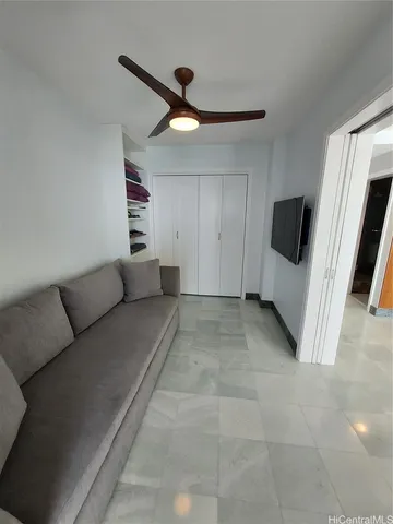 a view of a livingroom with furniture and a ceiling fan