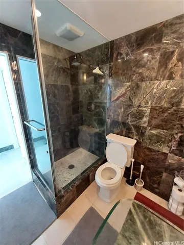 a bathroom with a toilet and a shower