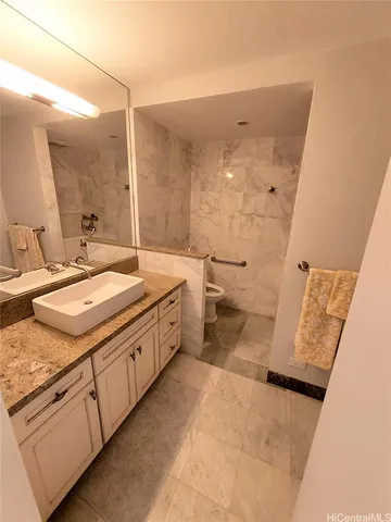 a spacious bathroom with a granite countertop sink mirror and a toilet