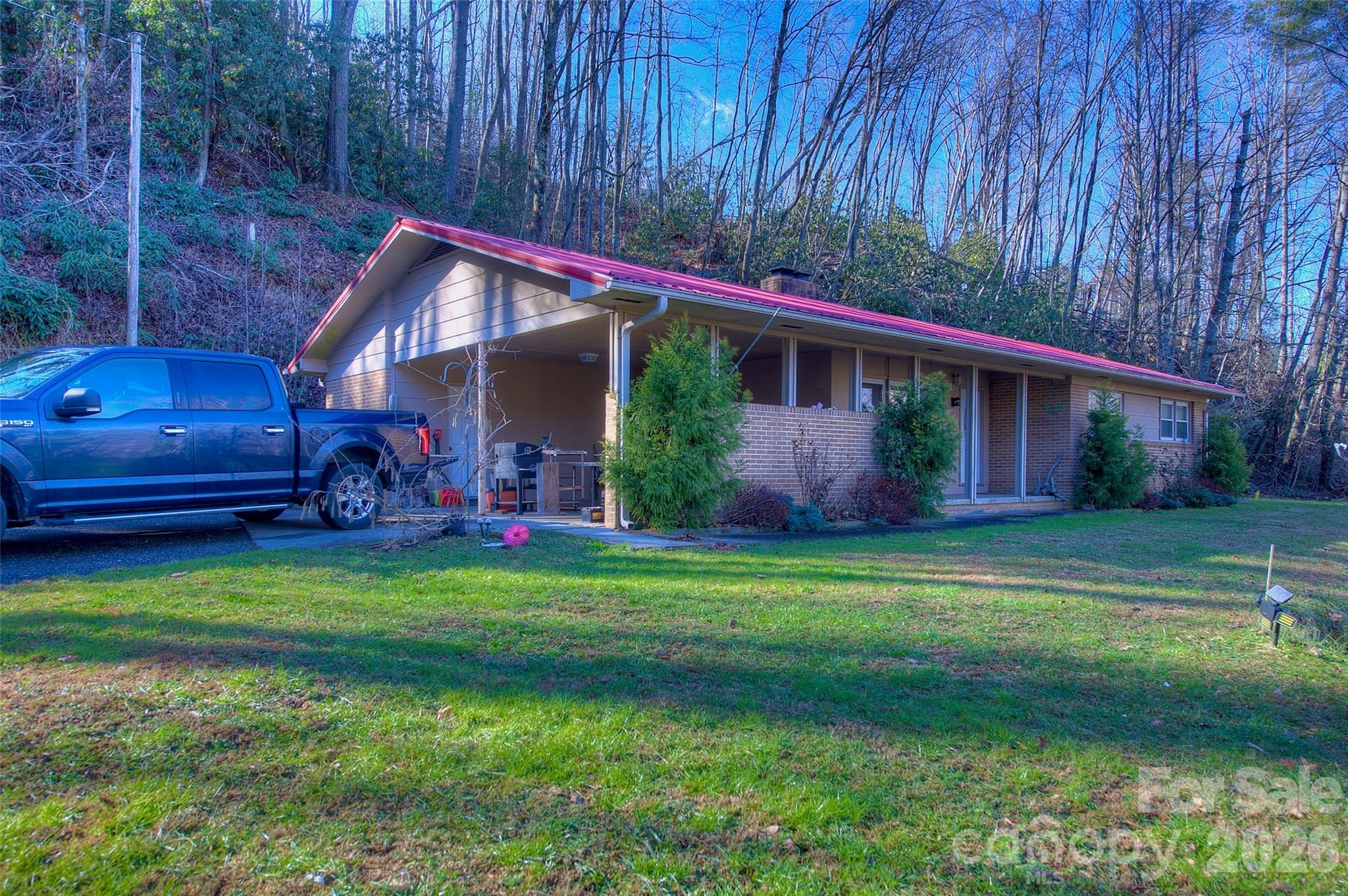 583 Deer Park Lake Road Spruce Pine, NC 28777 - Photo 1 of 24 a backyard of a house with wooden fence and a yard