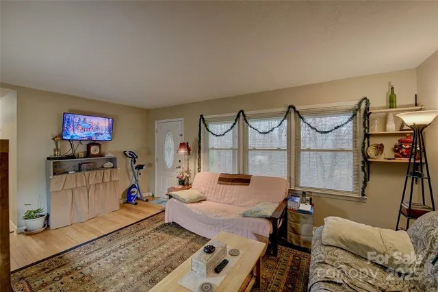 a bedroom with furniture and a flat screen tv
