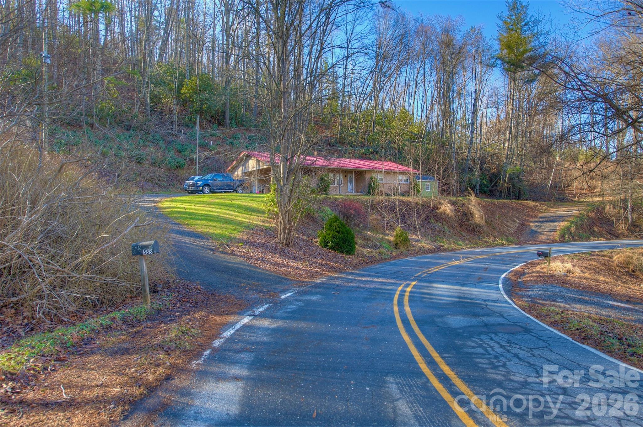 583 Deer Park Lake Road Spruce Pine, NC 28777 - Photo 17 of 24 a front view of a house with garden
