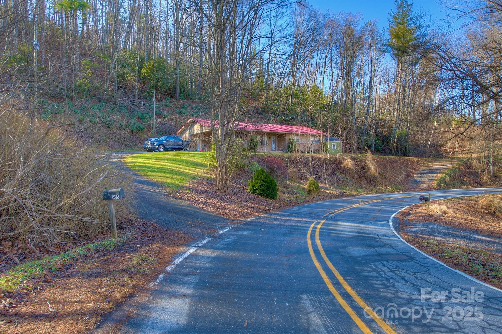 583 Deer Park Lake Road Spruce Pine, NC 28777 - Photo 17 of 24 a front view of a house with garden