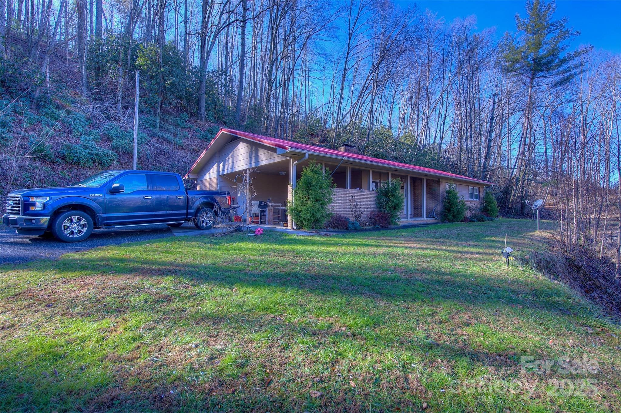 583 Deer Park Lake Road Spruce Pine, NC 28777 - Photo 19 of 24 a view of a house with a yard
