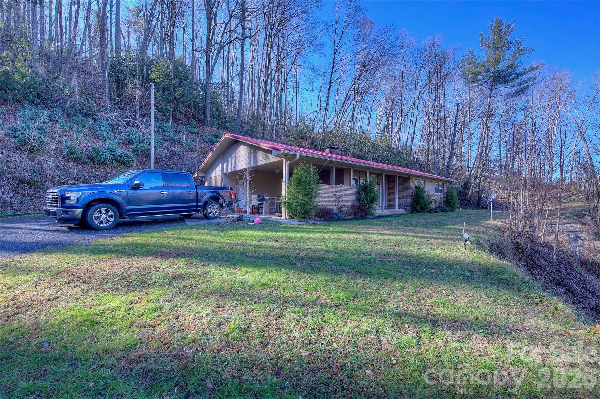 583 Deer Park Lake Road Spruce Pine, NC 28777 - Photo 20 of 24 a front view of a house with garden