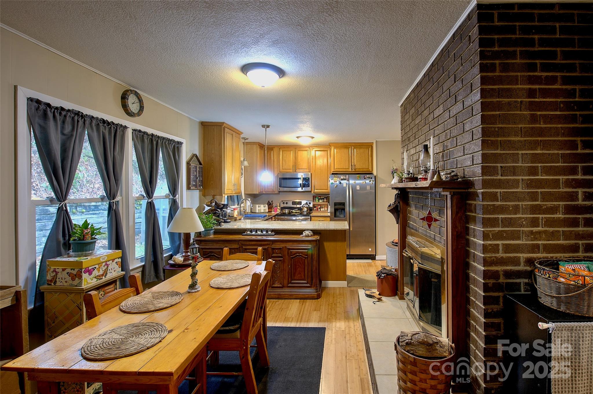 583 Deer Park Lake Road Spruce Pine, NC 28777 - Photo 3 of 24 a view of a dining room with furniture window and wooden floor