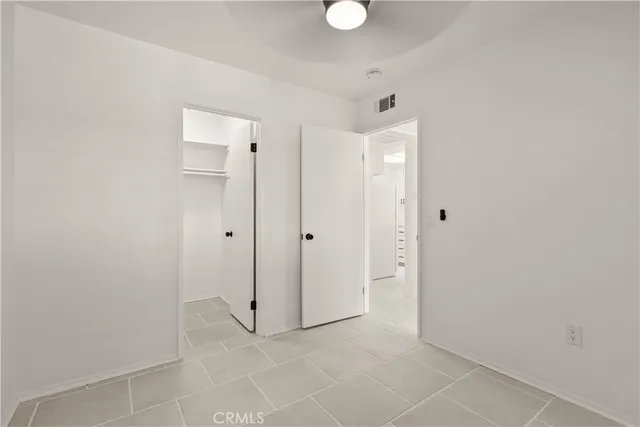 a kitchen with white cabinets and appliances
