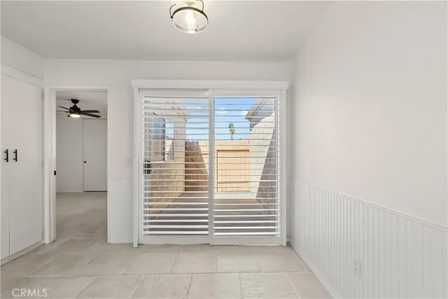 a view of an empty room with a ceiling fan