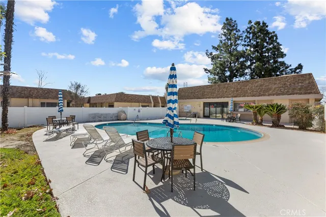 a view of a house with swimming pool and sitting area