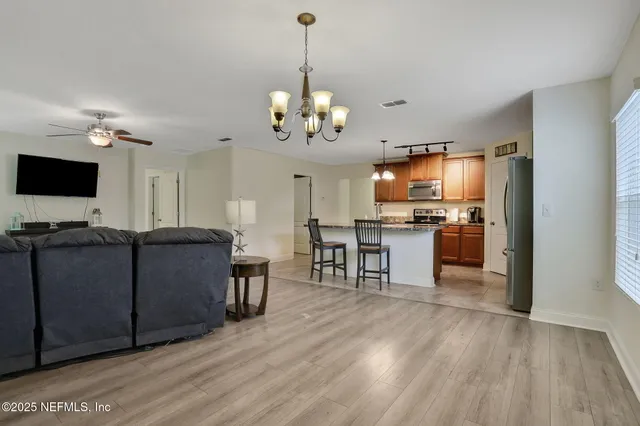a kitchen with stainless steel appliances granite countertop a refrigerator and a sink