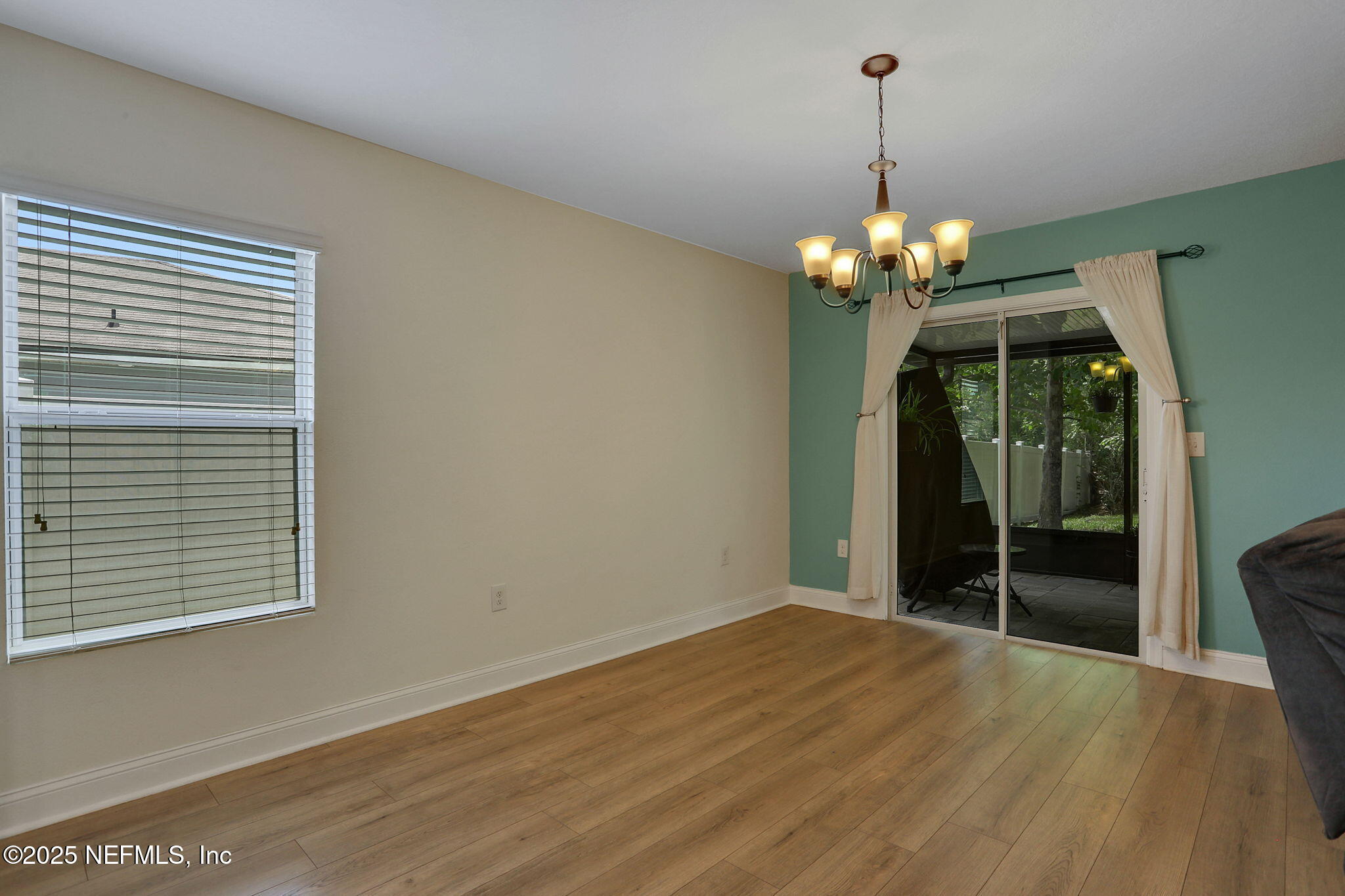 35 Root Lane St. Augustine, FL 32084 - Photo 17 of 37 a view of a livingroom with a chandelier wooden floor and windows