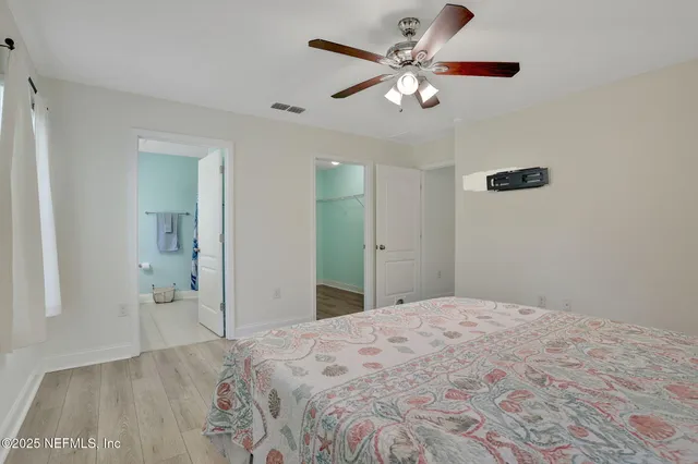 a spacious bedroom with a bed and a chandelier