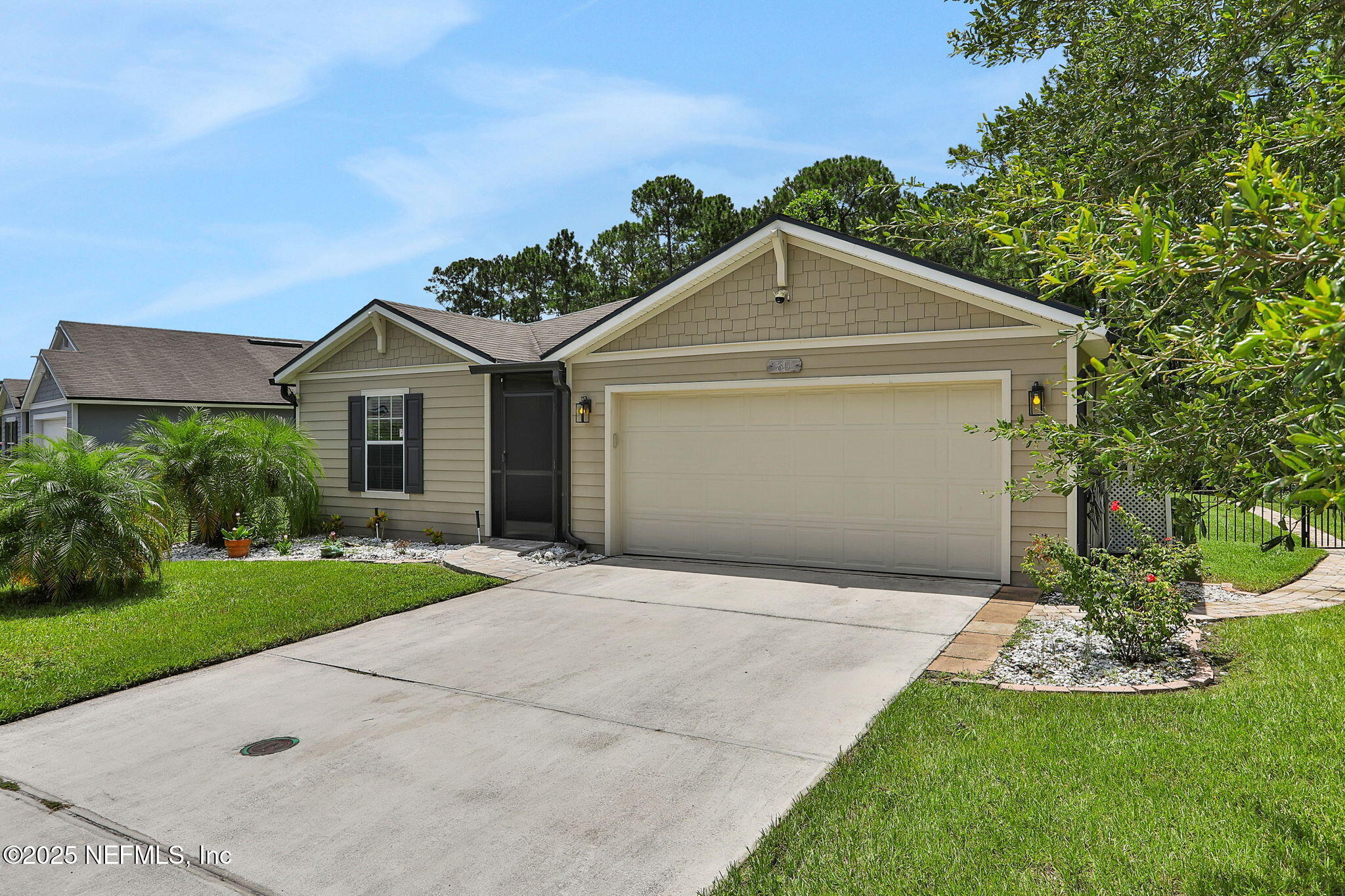 35 Root Lane St. Augustine, FL 32084 - Photo 5 of 37 a front view of a house with a yard and garage