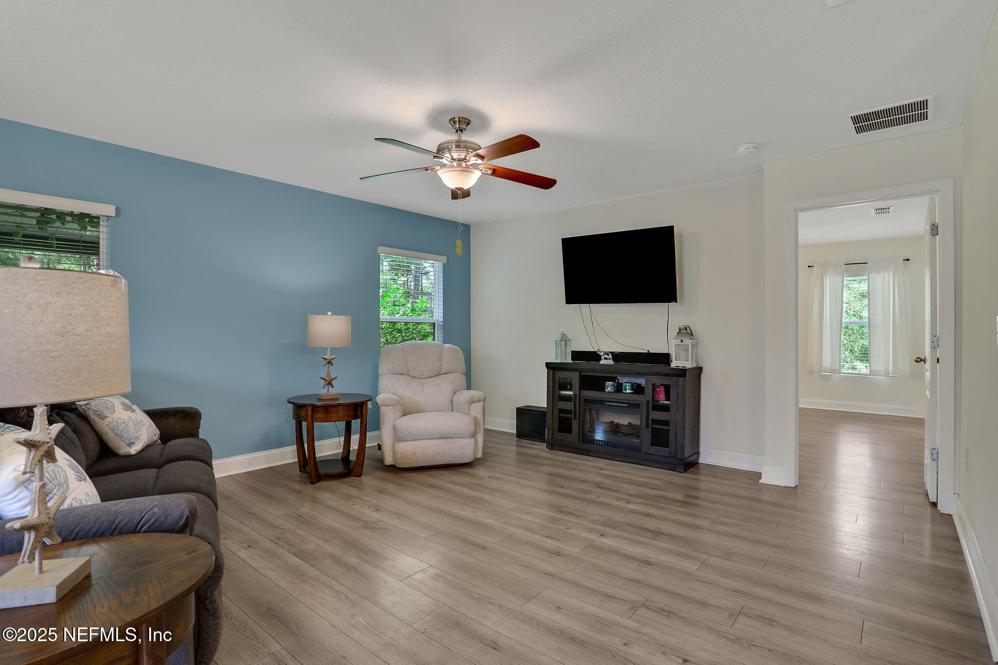 35 Root Lane St. Augustine, FL 32084 - Photo 10 of 37 a living room with furniture and a flat screen tv with wooden floor