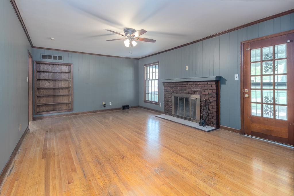 2448 Elmore Park Road Bartlett, TN 38134 - Photo 13 of 28 wooden floor fireplace and windows in an empty room
