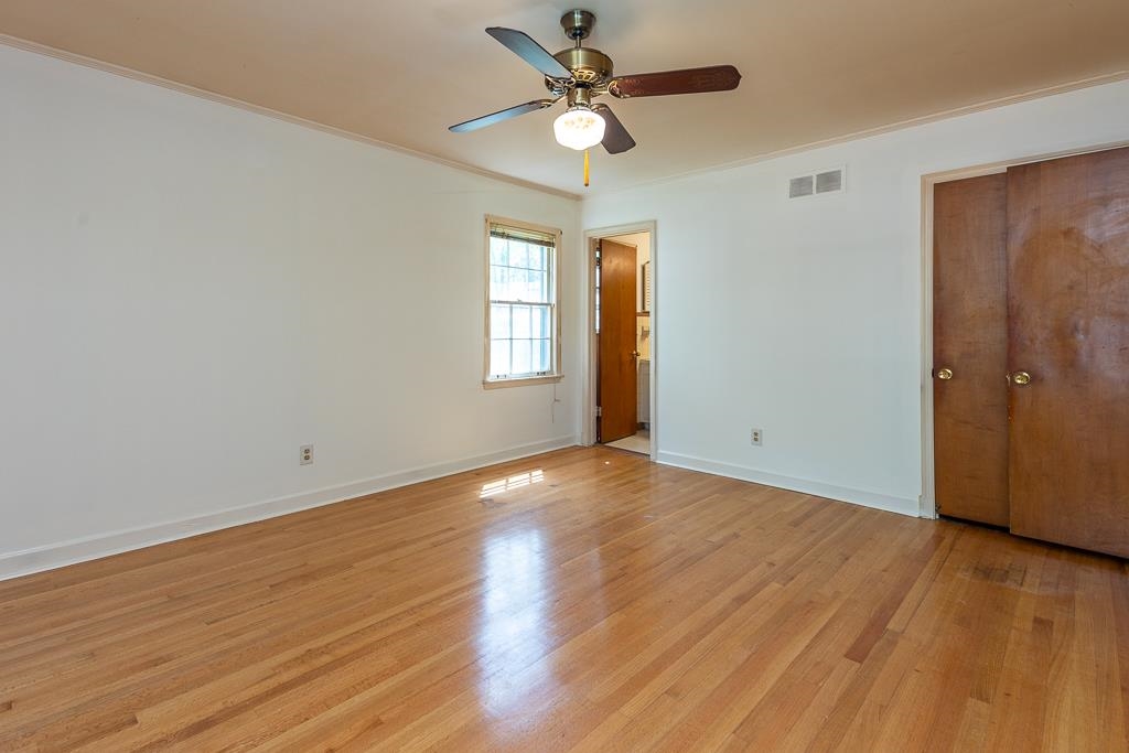 2448 Elmore Park Road Bartlett, TN 38134 - Photo 16 of 28 wooden floor in an empty room with a window