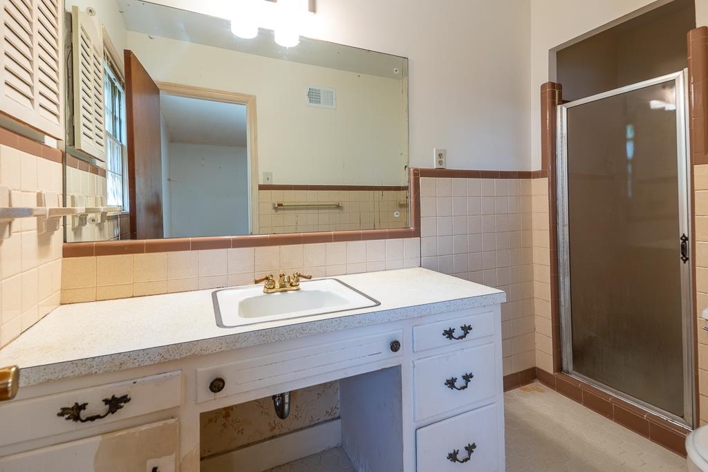 2448 Elmore Park Road Bartlett, TN 38134 - Photo 17 of 28 a bathroom with a sink and a mirror