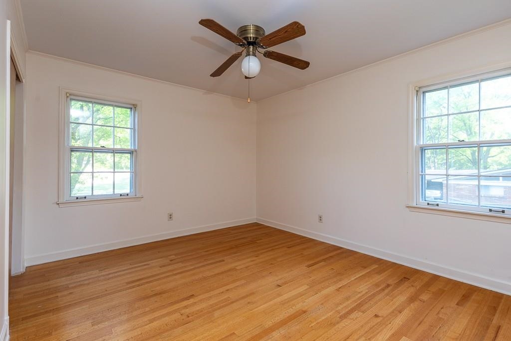 2448 Elmore Park Road Bartlett, TN 38134 - Photo 19 of 28 wooden floor in an empty room with a window