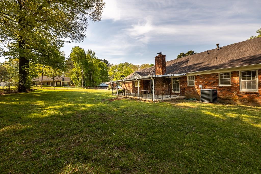 2448 Elmore Park Road Bartlett, TN 38134 - Photo 22 of 28 a view of a house with a big yard and a large tree