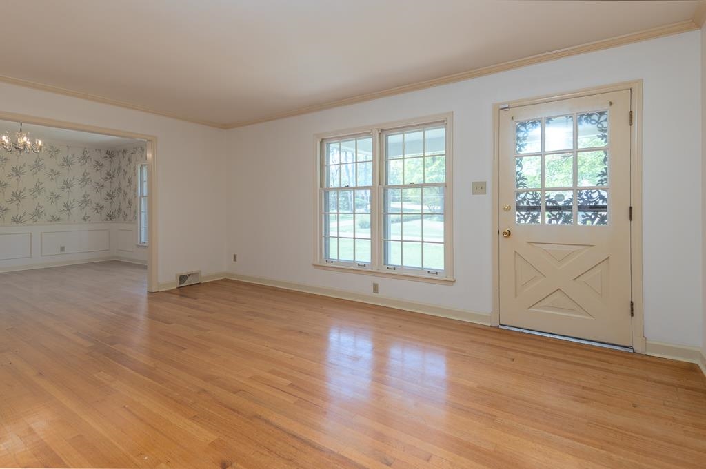2448 Elmore Park Road Bartlett, TN 38134 - Photo 5 of 28 an empty room with wooden floor and windows