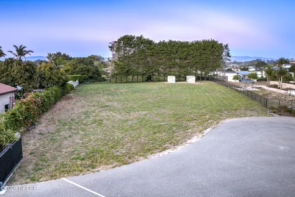 a view of a field with ocean view