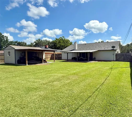 a view of a house with a swimming pool and a yard