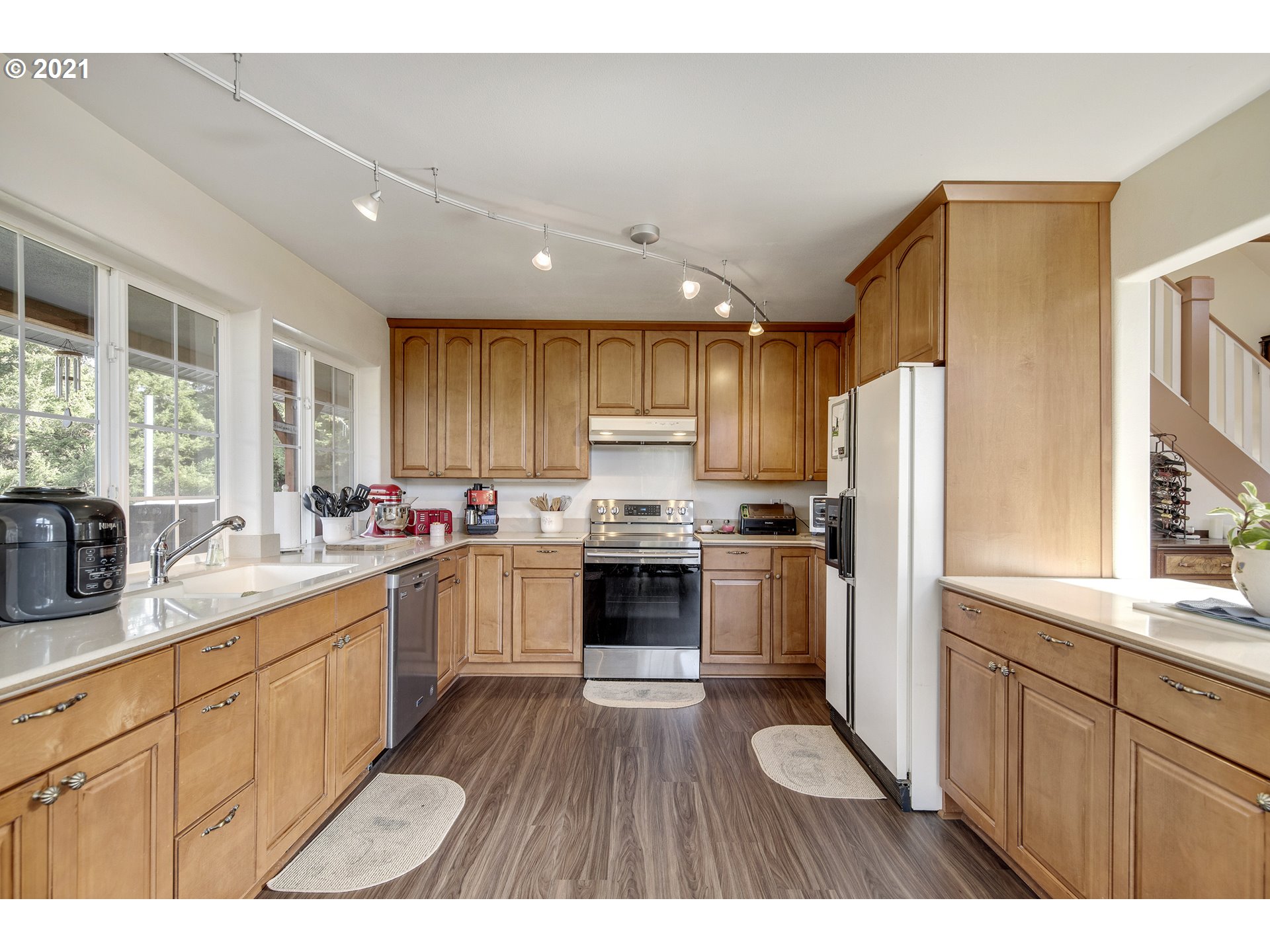 46400 Southwest Hebo Road Grand Ronde, OR 97347 - Photo 9 of 26 a kitchen with a refrigerator a sink dishwasher with a oven and wooden cabinets