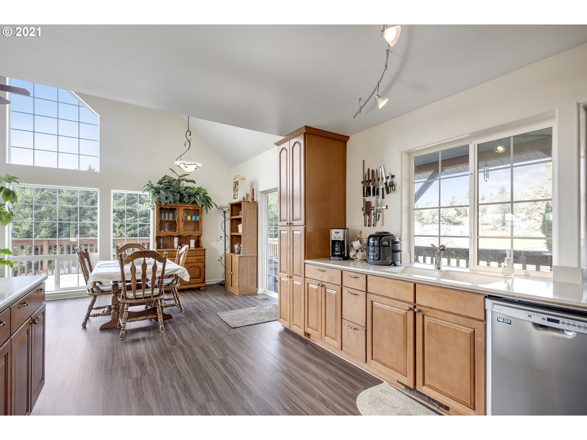 46400 Southwest Hebo Road Grand Ronde, OR 97347 - Photo 10 of 26 a open kitchen with granite countertop a stove dining table chairs and wooden floor