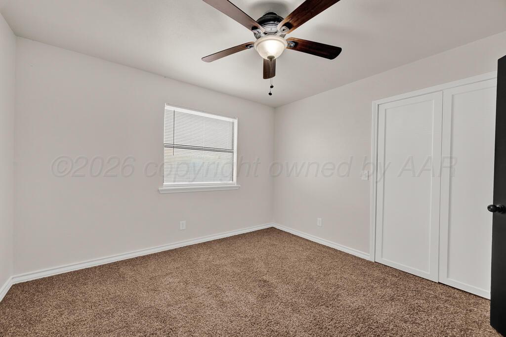 8027 Simpson Drive Amarillo, TX 79121 - Photo 17 of 32 an empty room with a window and a fan